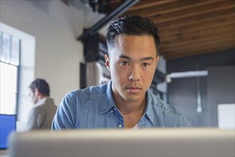 Businessman working at computer in office