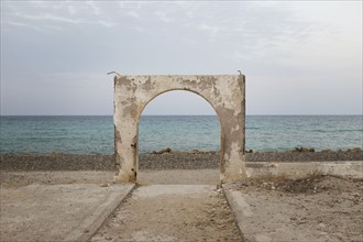 Stone arch over beach
