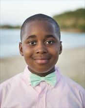 Black boy wearing bow tie outdoors