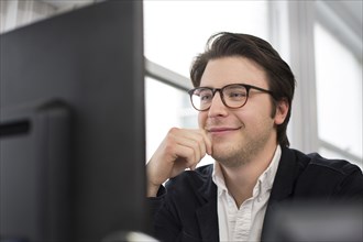 Caucasian businessman using computer in office