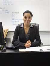 African American businesswoman sitting at desk in office