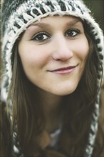 Close up of smiling Caucasian woman wearing knitted hat