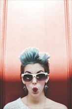 Stylish Caucasian woman with sunglasses and dyed hair