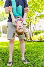 Caucasian father and daughter playing in backyard