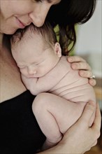 Caucasian mother holding newborn baby
