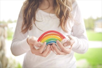 Caucasian girl holding rainbow candy