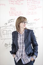 Businesswoman standing at whiteboard in office