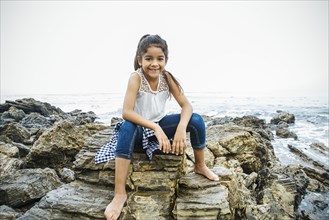 Hispanic girl exploring tide pools
