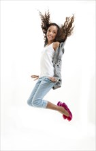 Mixed race girl jumping for joy