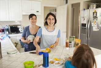 Caucasian family eating breakfast in kitchen