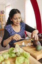 Hispanic woman cooking in kitchen