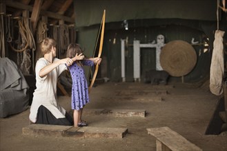 Children practicing archery with target