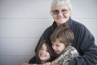 Caucasian grandmother and grandchildren smiling outdoors