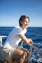 Caucasian woman sitting on boat deck