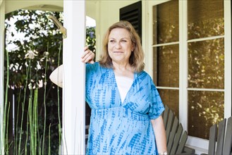 Caucasian woman standing on porch