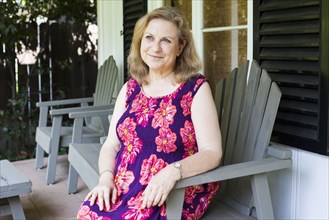 Caucasian woman sitting on porch