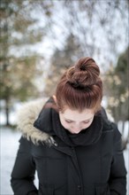 Caucasian teenage girl wearing parka outdoors