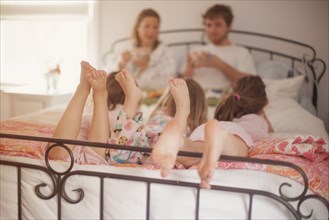 Caucasian family eating breakfast in bed