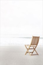 Empty folding chair on beach