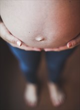 Close up of belly of pregnant Caucasian woman