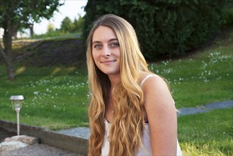 Caucasian teenage girl smiling in park