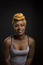 Smiling Black woman wearing headwrap