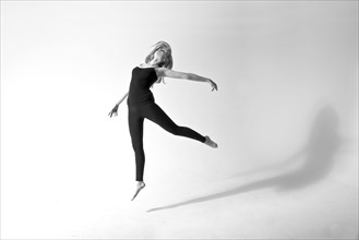 Caucasian dancer jumping for joy