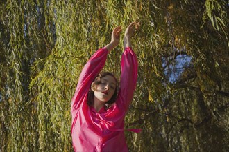 Woman standing under tree in park