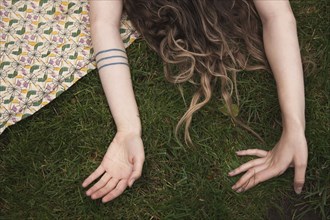 Woman laying on blanket in grass