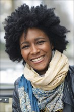 Smiling Black woman wearing scarves