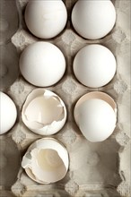 Close up of carton of eggs and eggshells