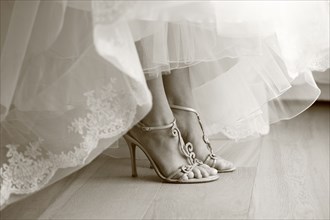 Close up of feet of bride in wedding shoes