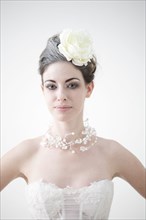 Caucasian bride wearing flower and birdcage veil