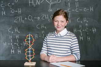 Caucasian student with molecular model in science class