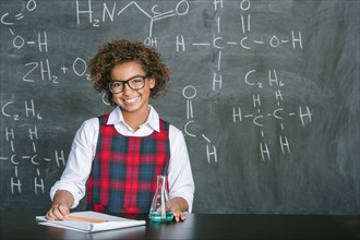 Mixed race student doing experiment in science class