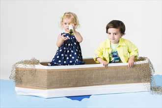 Children playing in cardboard boat