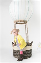 Girl playing in pretend hot air balloon
