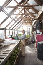 Gardener working in greenhouse