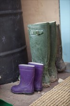 Close up of rain boots of adult and child