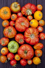 Close up of variety of fresh tomatoes on board