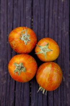 Close up of variety of fresh tomatoes on board