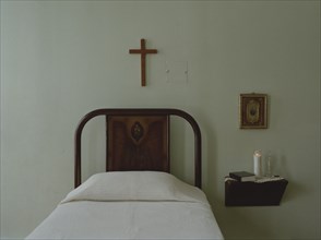 Crucifix over bed in simple bedroom