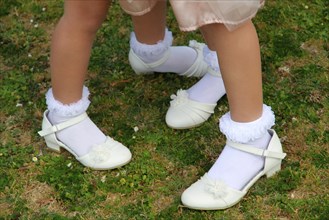Girls wearing dress shoes and socks in grass