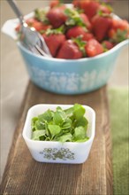 Bowls of fresh herbs and strawberries