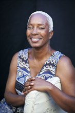 Smiling woman leaning on chair back