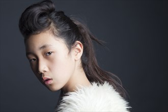 Serious Asian girl wearing fur shawl