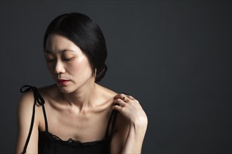 Disappointed Asian woman looking down