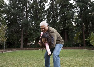 Father and daughter playing in backyard