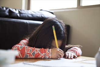 Close up of mixed race girl doing homework