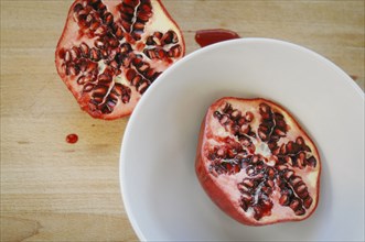 Close up of halved pomegranate on plate